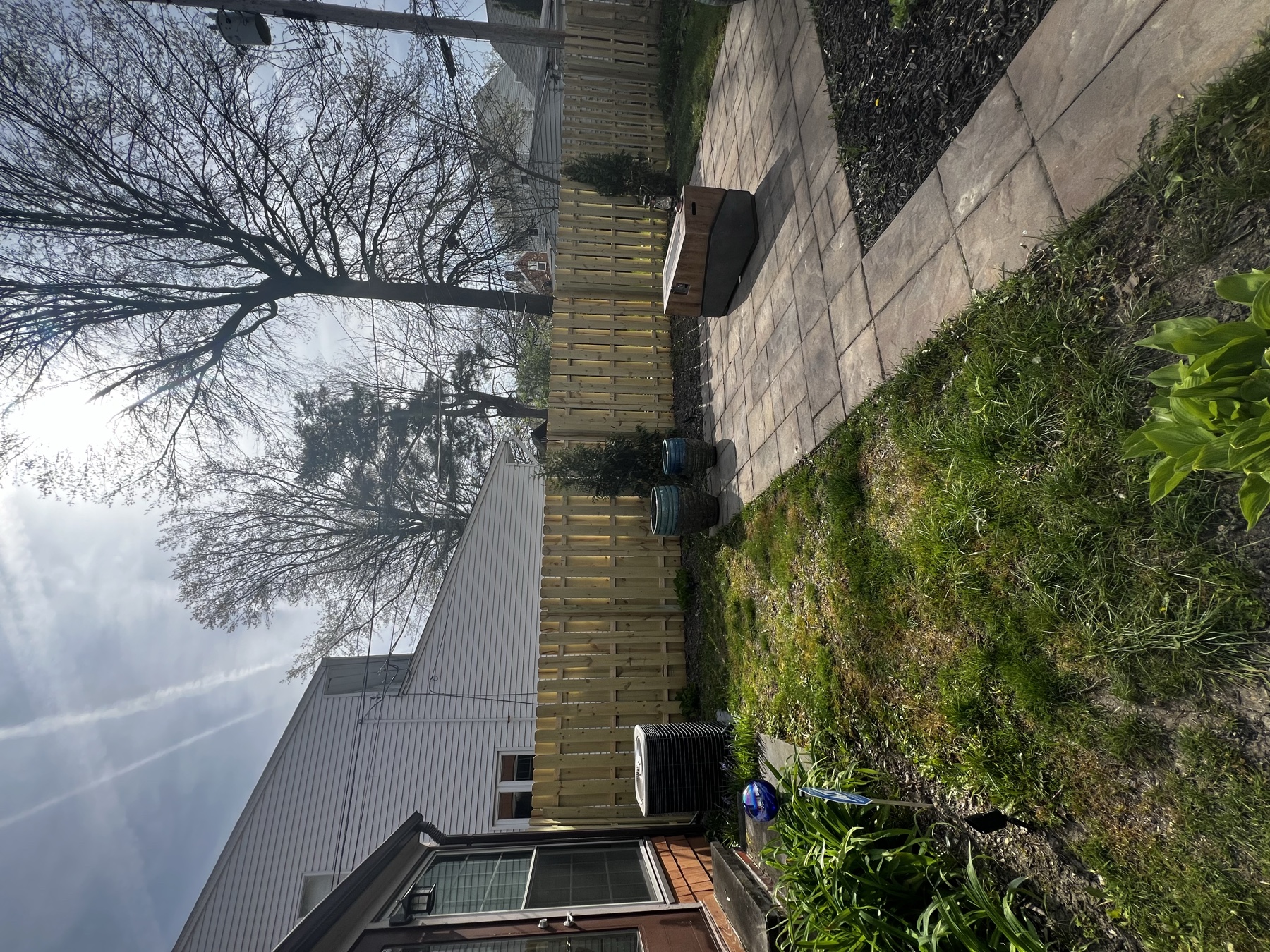 Backyard privacy fence installed along a patio and garden area