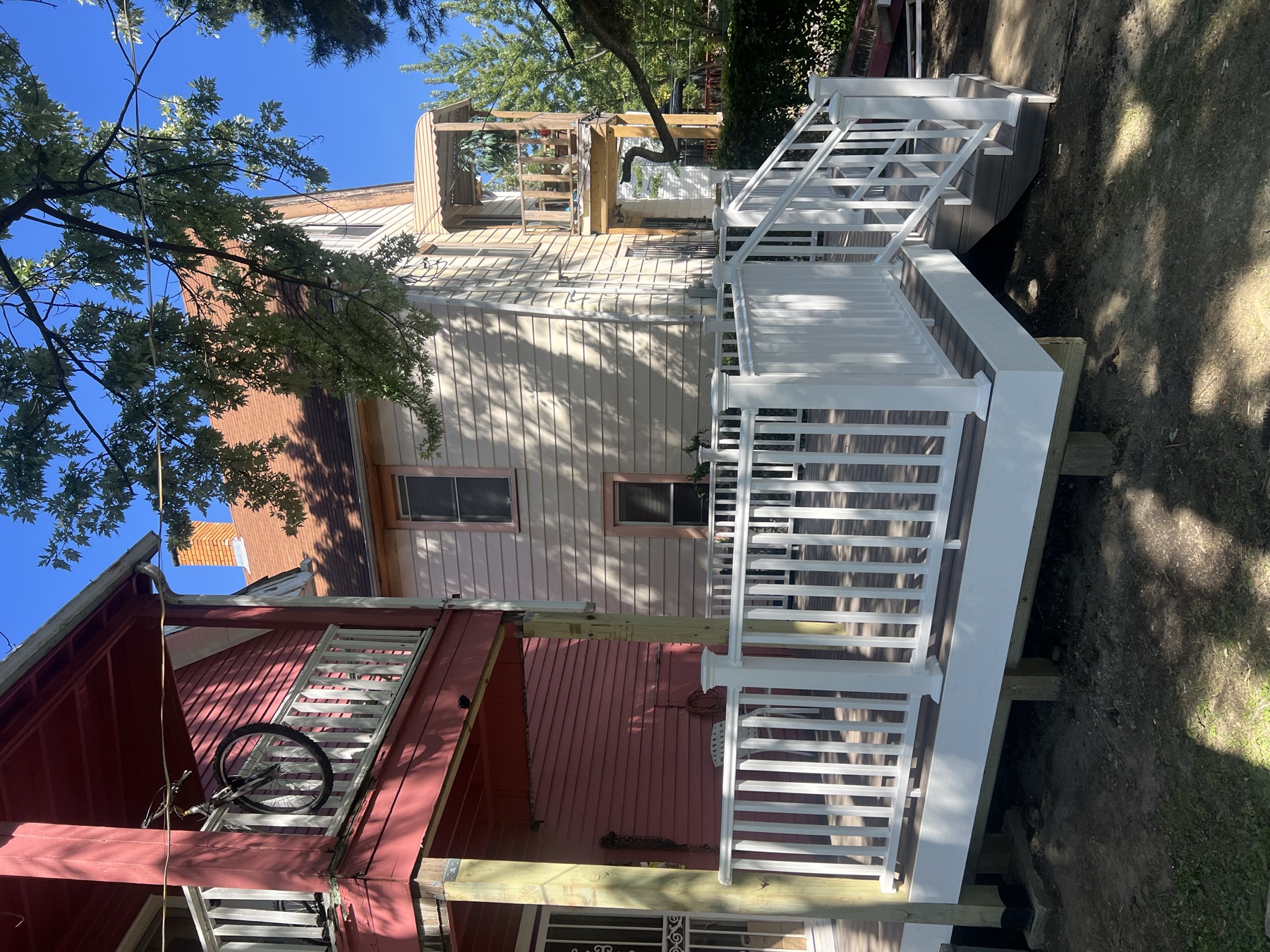 Composite deck with white railings and stairs completed by E and C Carpentry