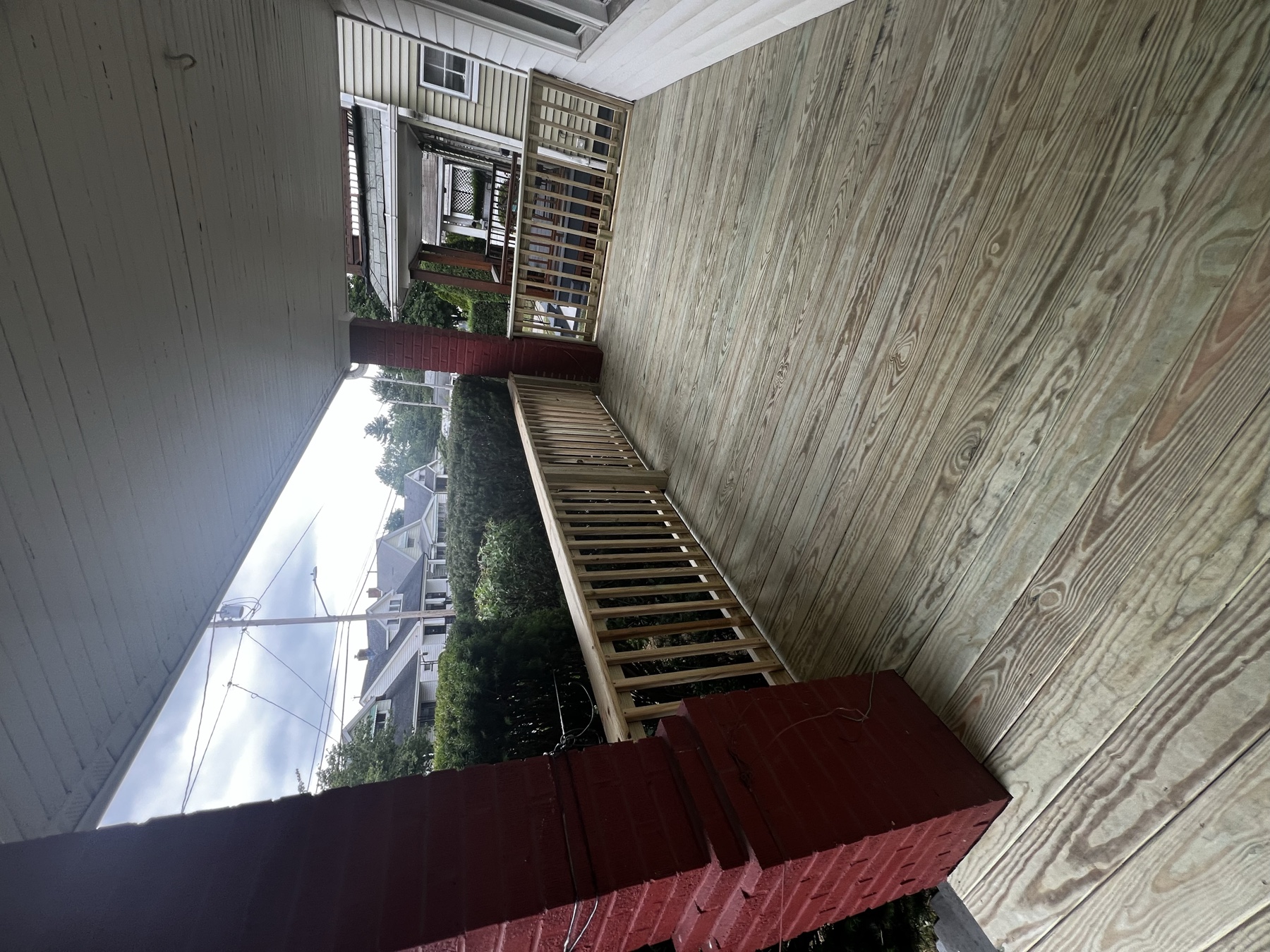 Covered porch with new wood decking and railings